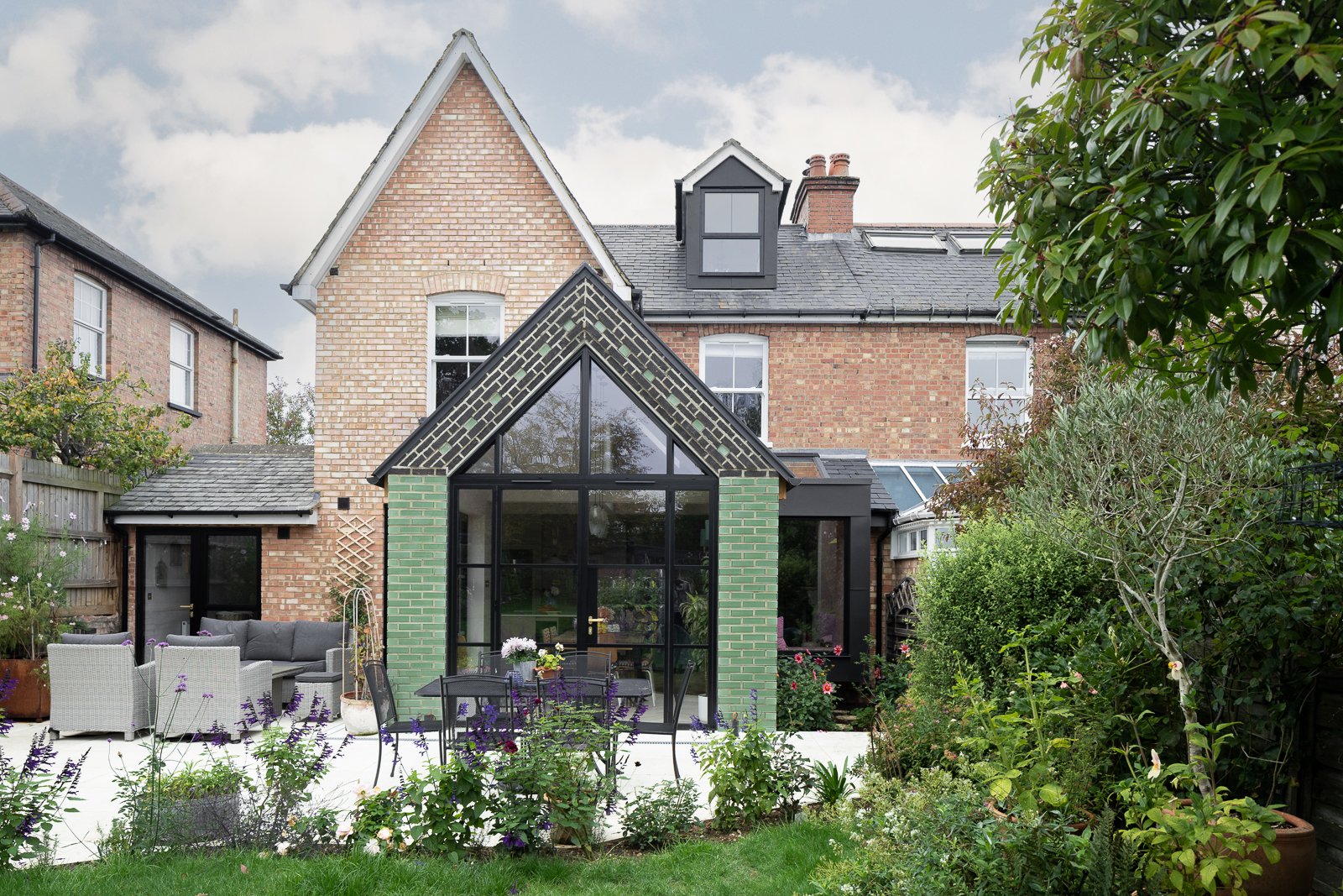 Green glazed-brick gabled extension with black steel-framed glazing, Lea Road
