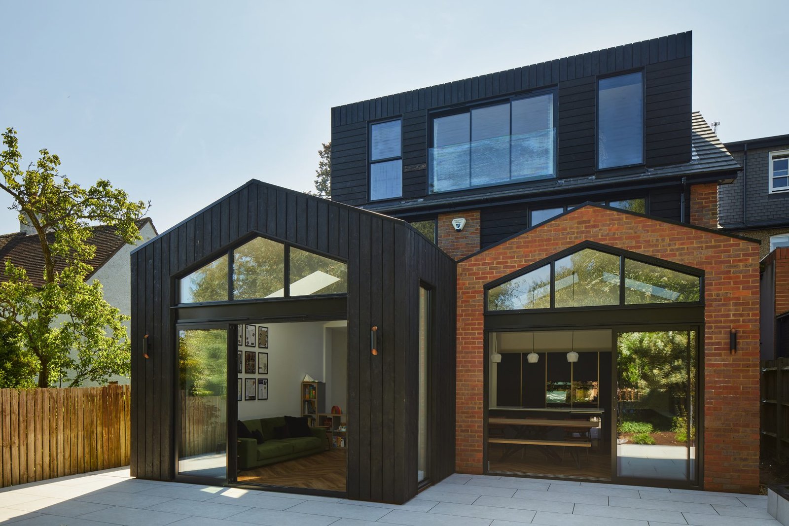 Black-clad twin-gable rear extension with full-height glazing, Harpenden